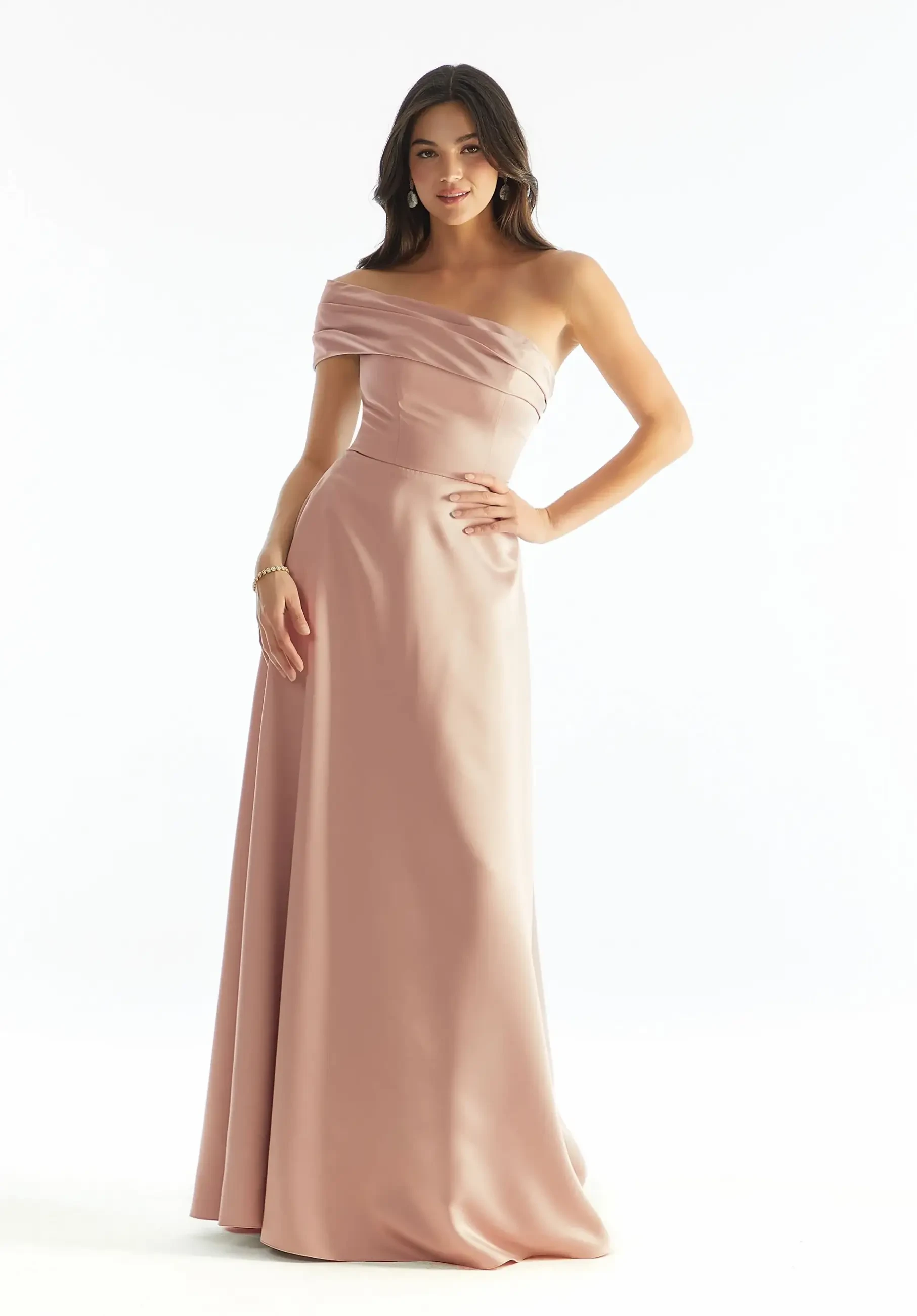 Model is wearing a blush one-shoulder luxe satin A-line bridesmaid dress with a cuffed neckline detail and structured bodice.