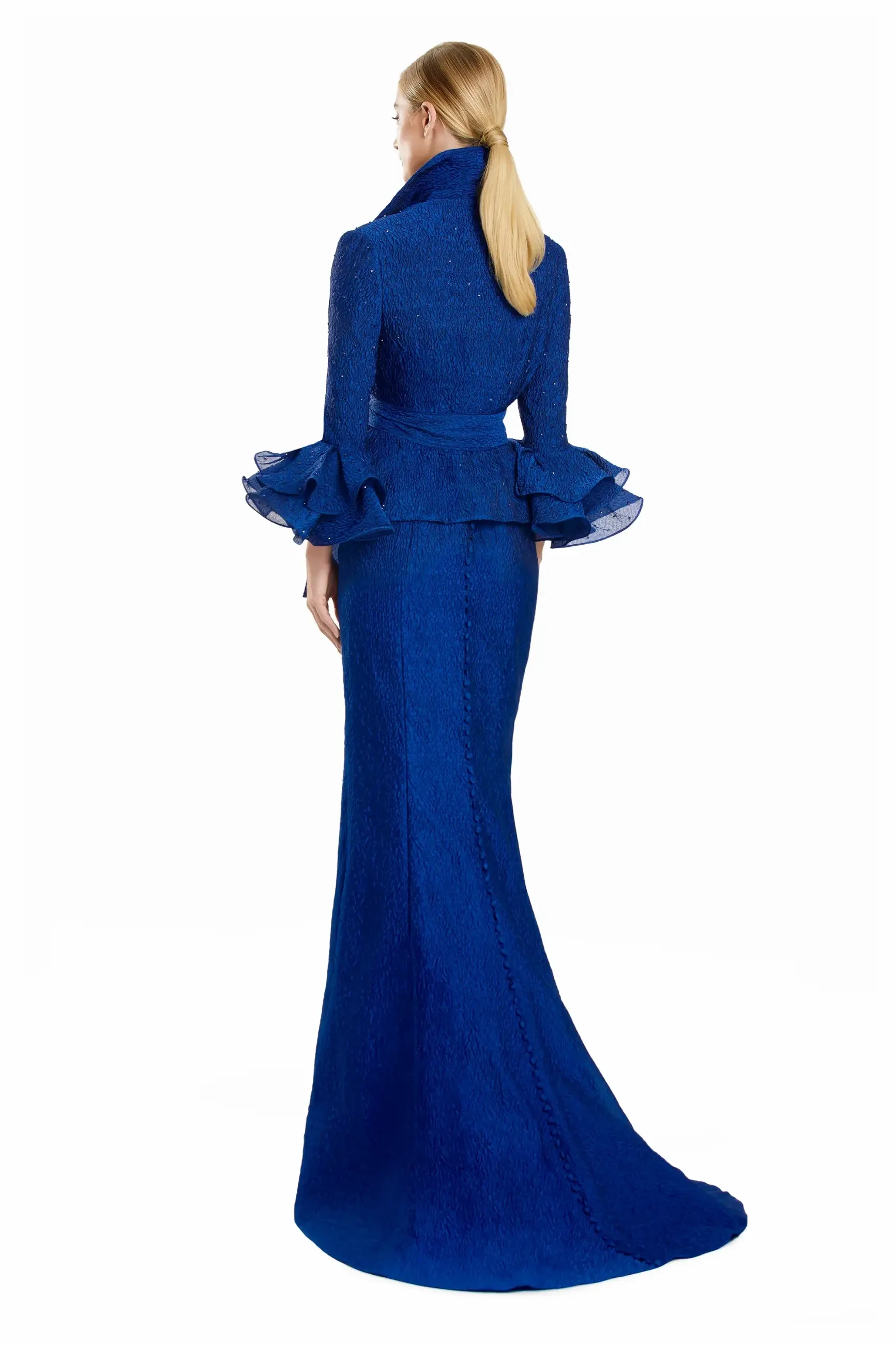 model is wearing a sapphire mother of the bride dress