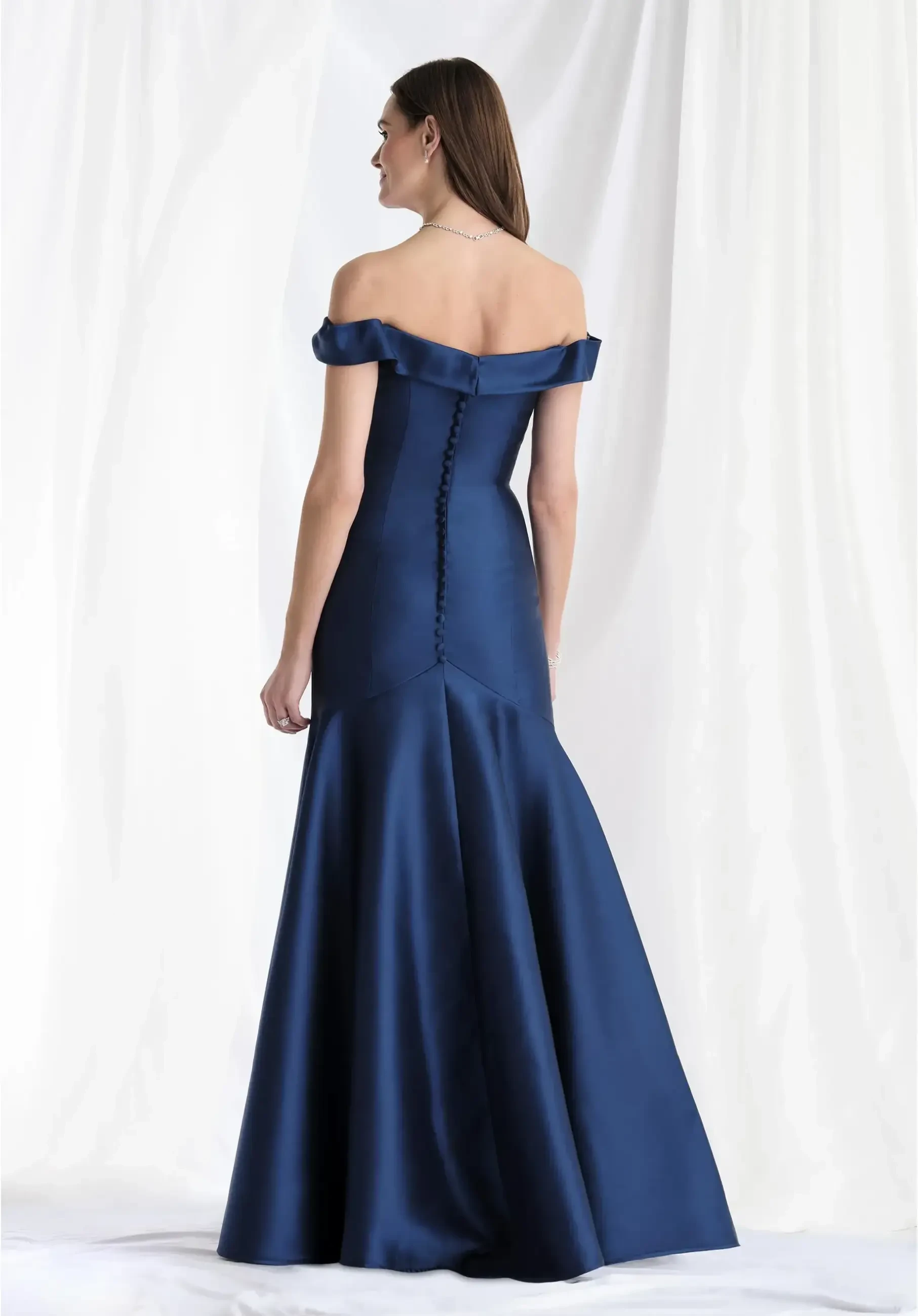 model is wearing a navy blue off the shoulder mother of the bride dress