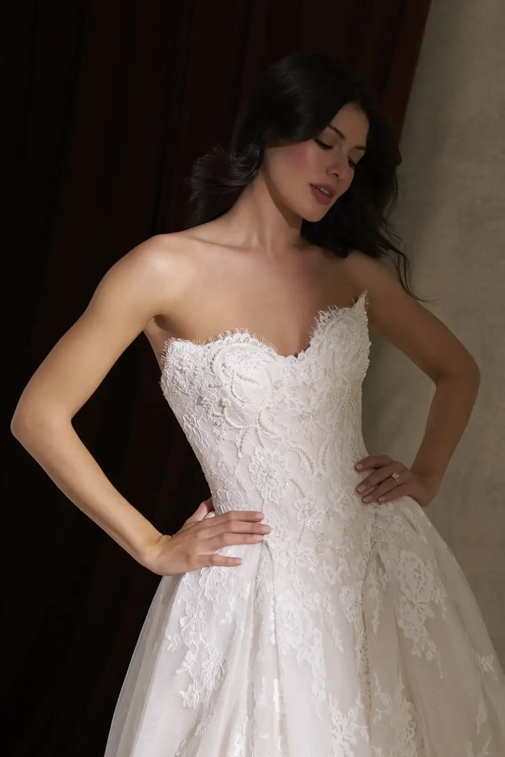 model is wearing a strapless wedding gown